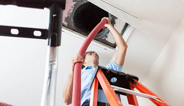 Close-up of HVAC ducts and installation process, demonstrating quality HVAC system setups and maintenance.