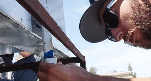 HVAC technician repairing an air conditioning unit in Sun Valley, Nevada.