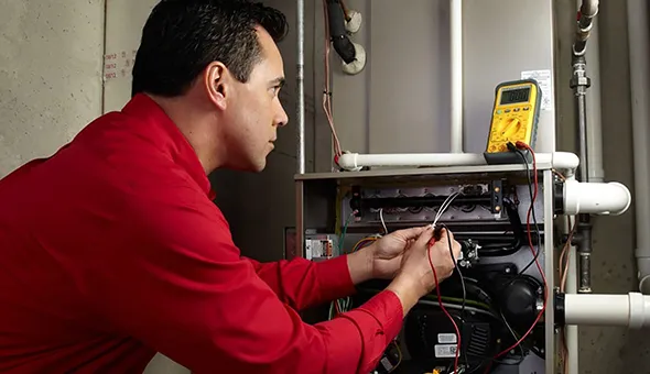 HVAC technician working on a furnace installation in Reno, NV, showcasing expert furnace replacement services.