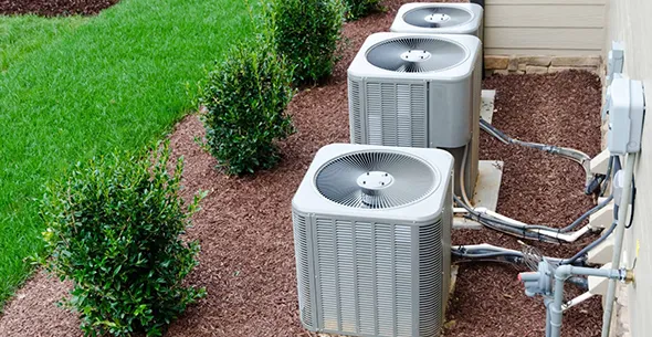 HVAC contractor inspecting equipment outside a home in Sun Valley, NV, representing trusted HVAC contracting services.