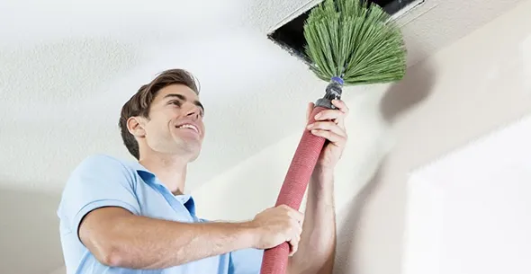 HVAC technician inspecting and repairing air ducts in Sun Valley, NV, showcasing expert air duct repair services.