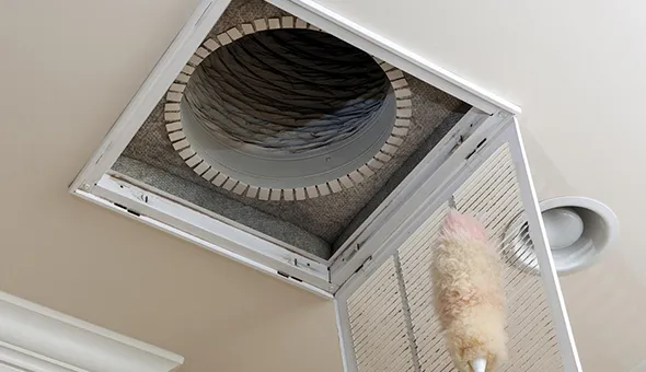 Technician performing HVAC duct cleaning in Spanish Springs, NV, highlighting professional services for maintaining clean air ducts.